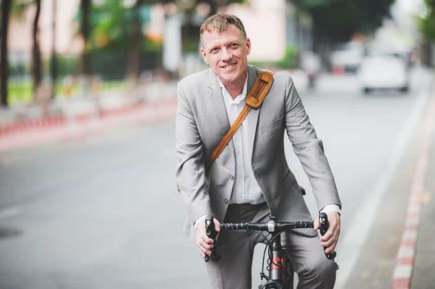 professional adult caucasian businessman person ride a bicycle to work
