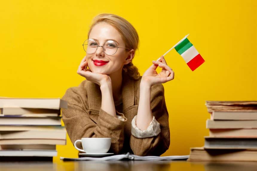 blonde woman with flag of Italy and books on yellow background