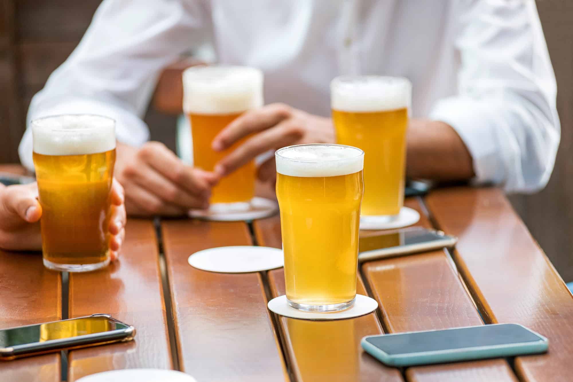 Glasses of ice cold beer on a pub table