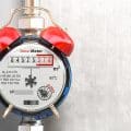 Water meter wiith alarm clock. Time to pay utility bills and debt for water consumption concept.