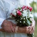 Close-up of seniors hands with wedding rings during their marriage.