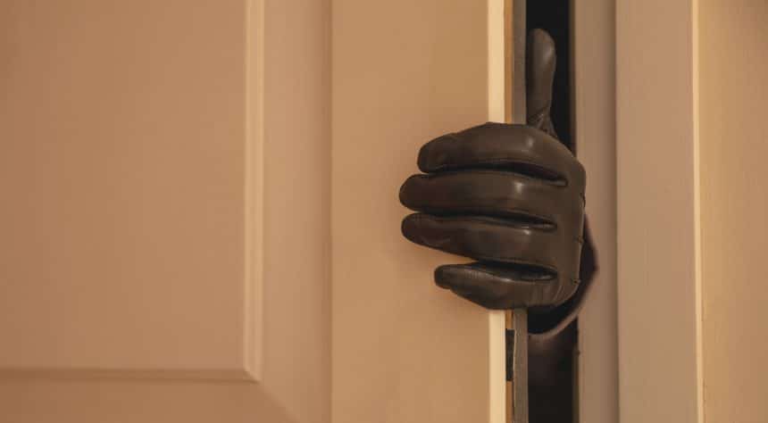 Gloved hand opening the door, Housebreaking, burglary concept