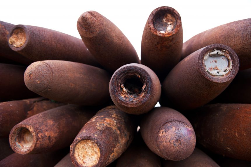 Closeup shot of a pile of old unexploded bombs.